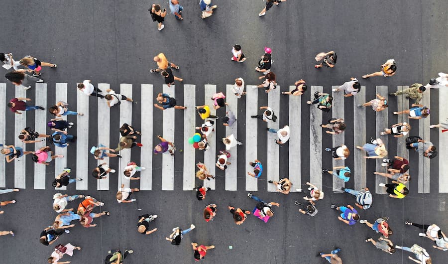 Pedestrians crossing the street by using a cross-walk